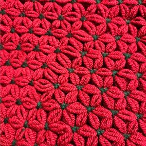 Beautiful crocheted placemats red and green flowers that look like poinsettias
